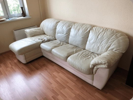 Worn cream leather sectional, before