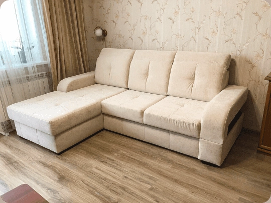 The same sofa-bed recovered in cream velvet in the same room