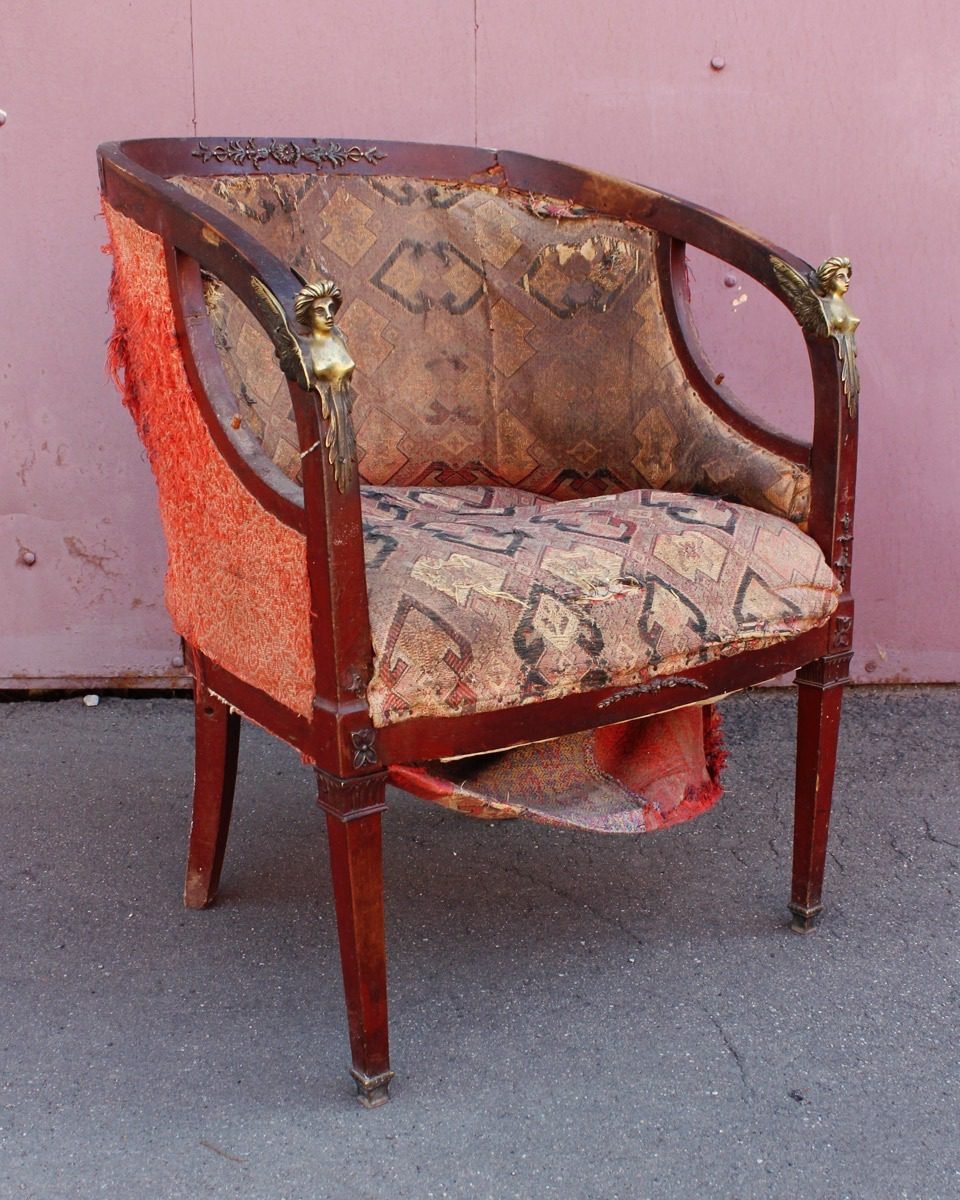 Empire barrel-back tub chair before restoration, cover worn through to the ground weave