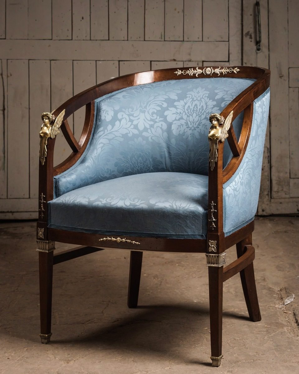 The same Empire tub chair after restoration in pale blue damask with cleaned gilt arm mounts