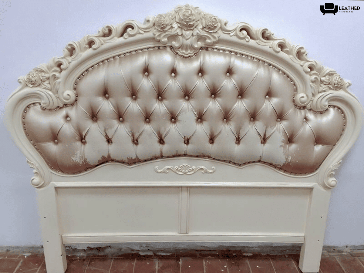 Carved headboard before reupholstery, buttoned champagne leather