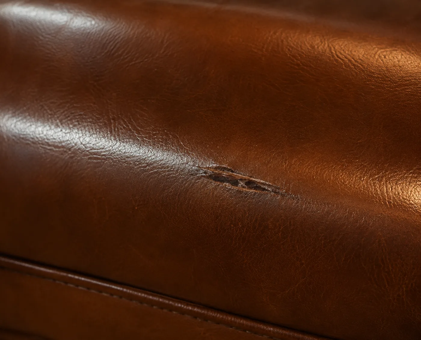 Clean cut through the leather of a banquette seat