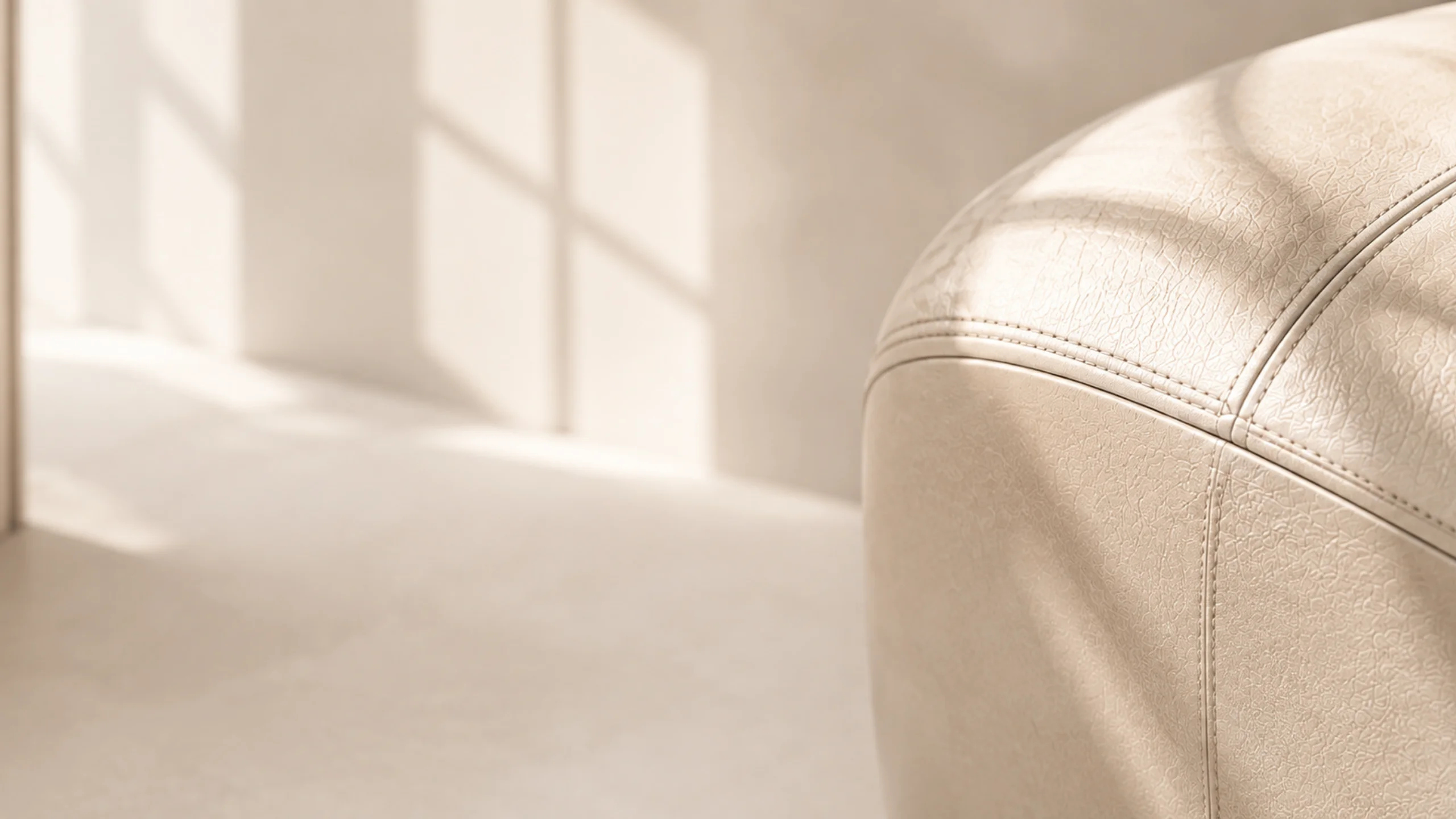 Cream leather armchair with an even restored finish
