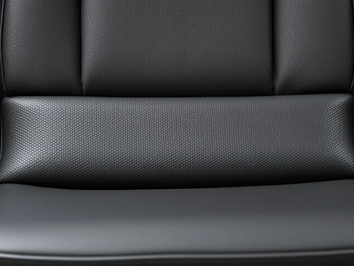 Dull, grimy black vinyl booth seat