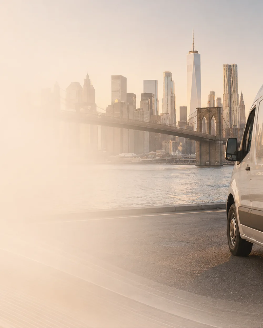 Van on the road toward the city skyline