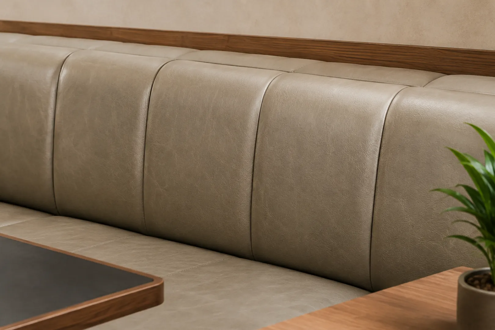 A grey channelled leather lobby bench showing wear
