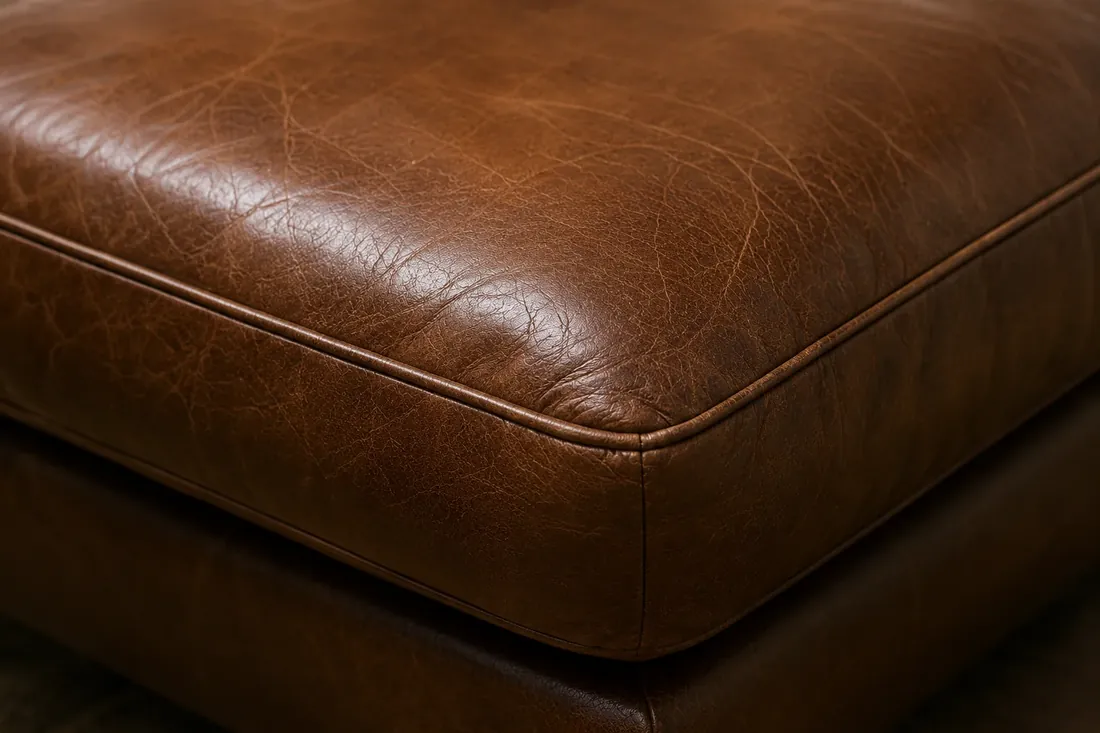 Brown leather seat cushion after hotel furniture restoration NYC, color and sheen even across the panel