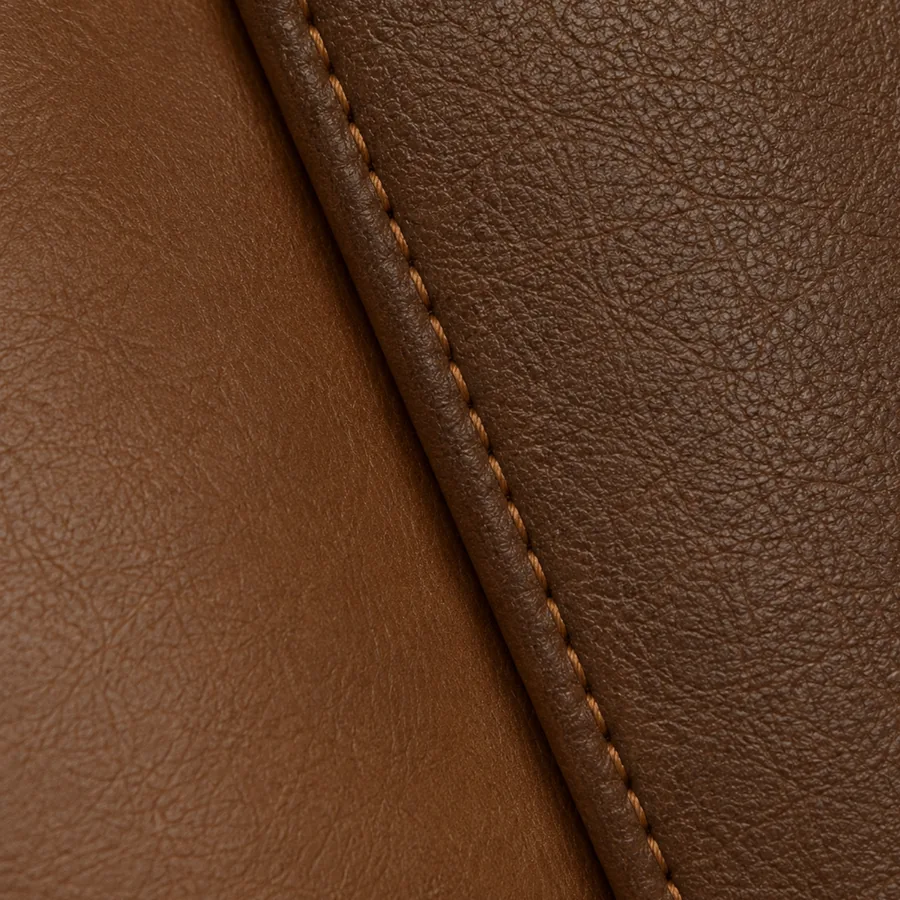 A close photograph of two brown leather panels meeting at a seam