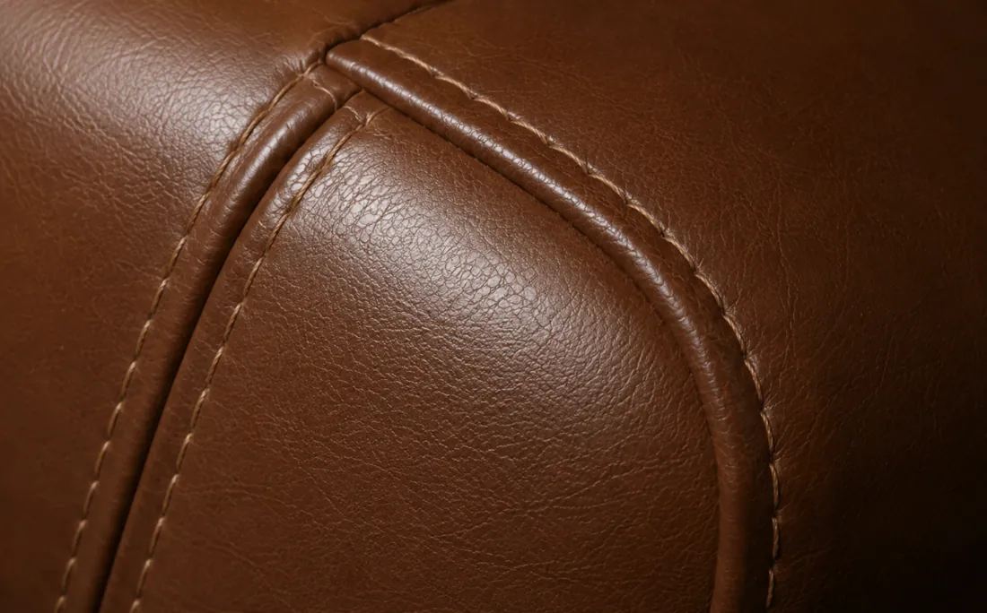 A replaced leather panel meeting its neighbour at a stitched seam