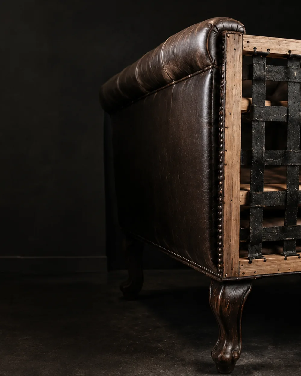 A leather sofa stripped to its frame for bench work