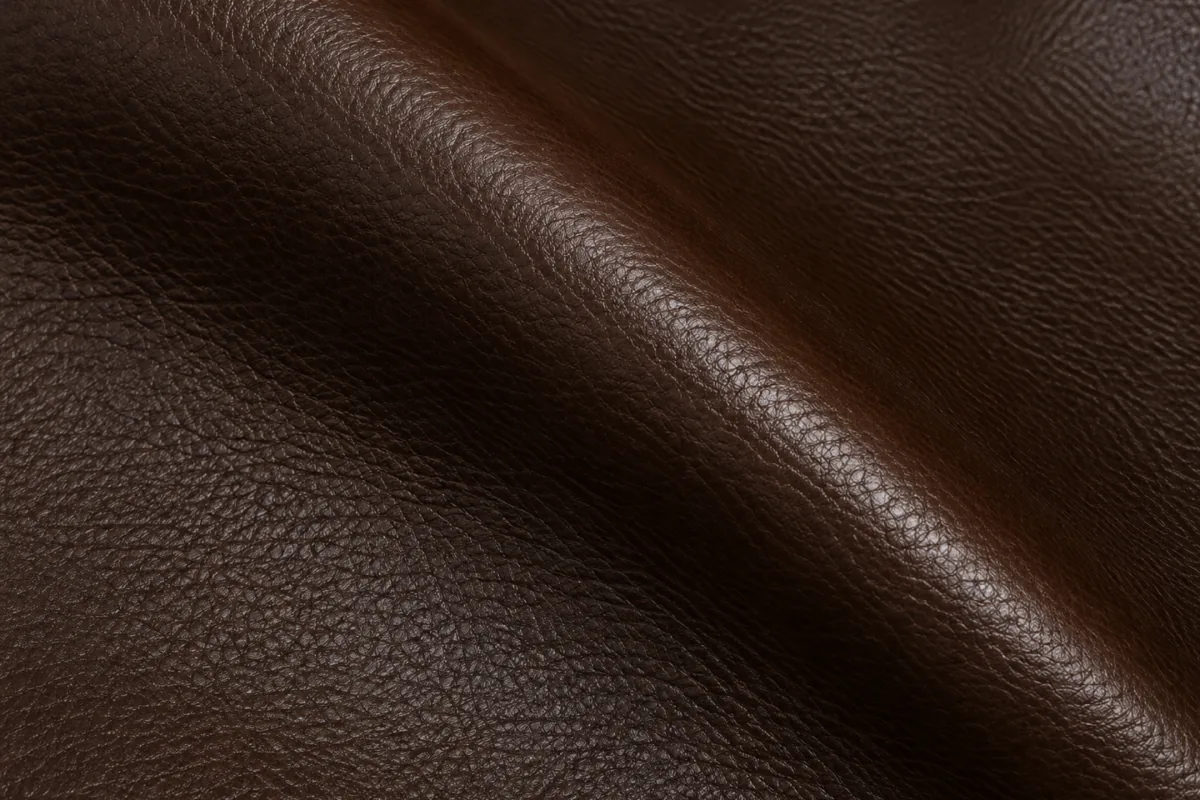 Pigmented leather swatch with an opaque colored topcoat and uniform embossed grain
