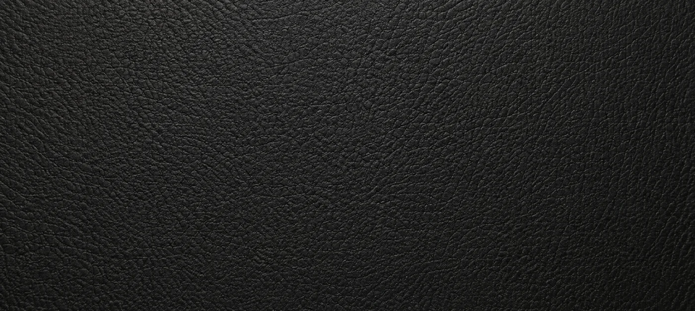 A black faux leather swatch with a fine uniform grain