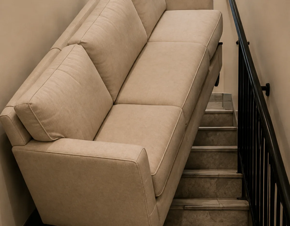A beige sofa too large to turn in a narrow stairwell
