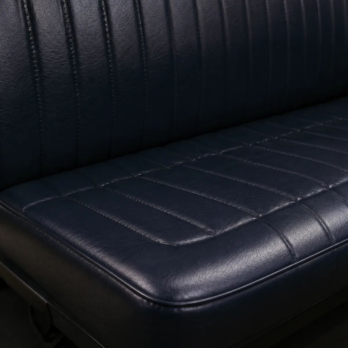A bench seat recovered in dark vinyl