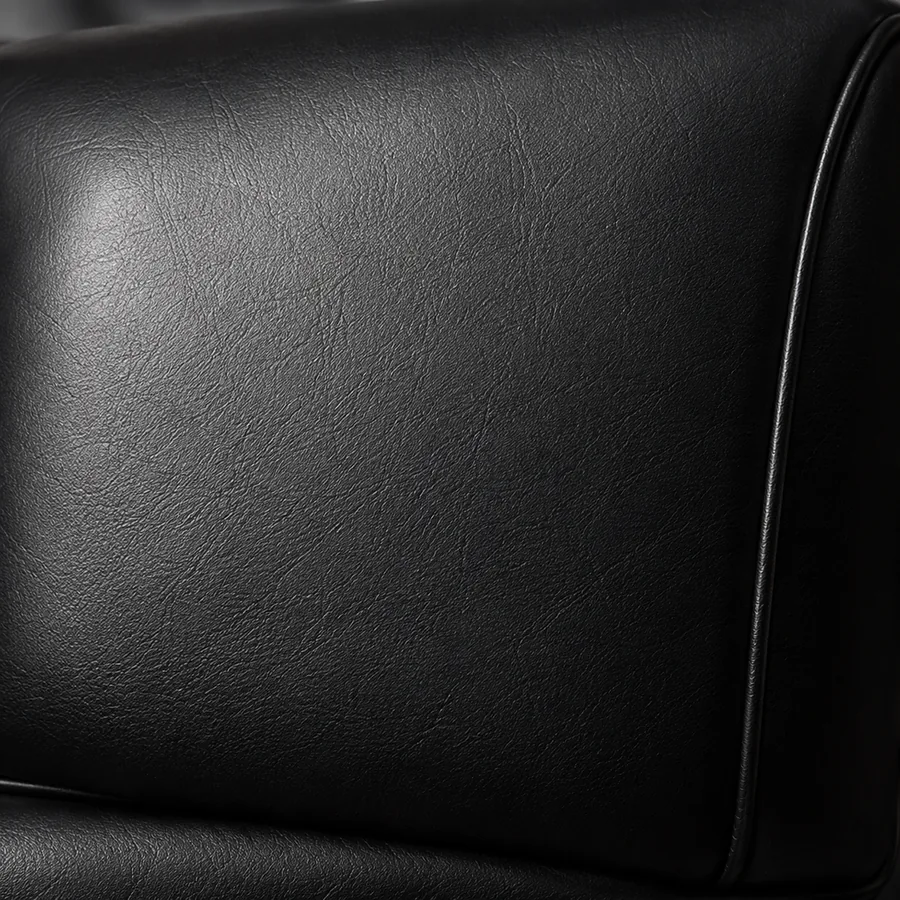 Smooth black leather restaurant seat panel with a welted edge