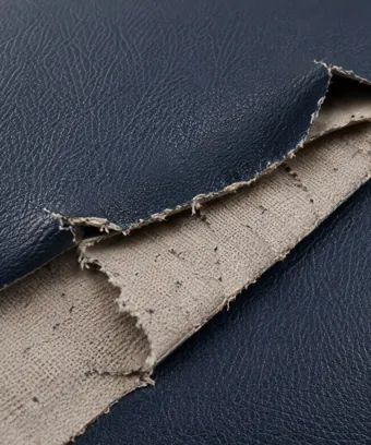 Vinyl film torn away from its fabric backing