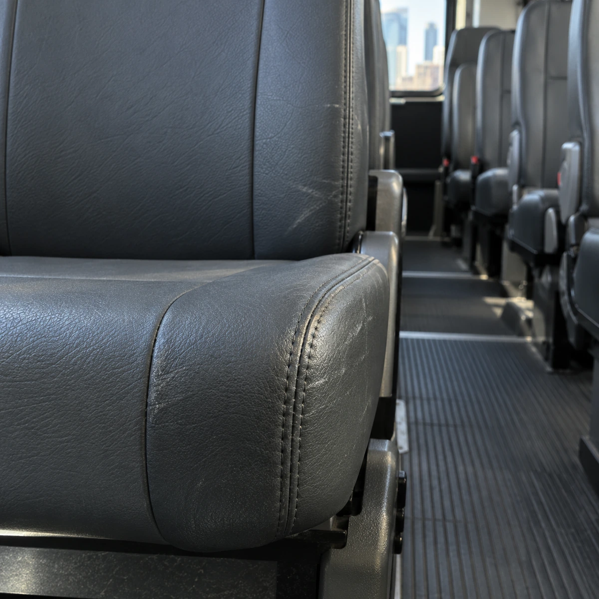 A scuffed aisle-side edge on a bus seat