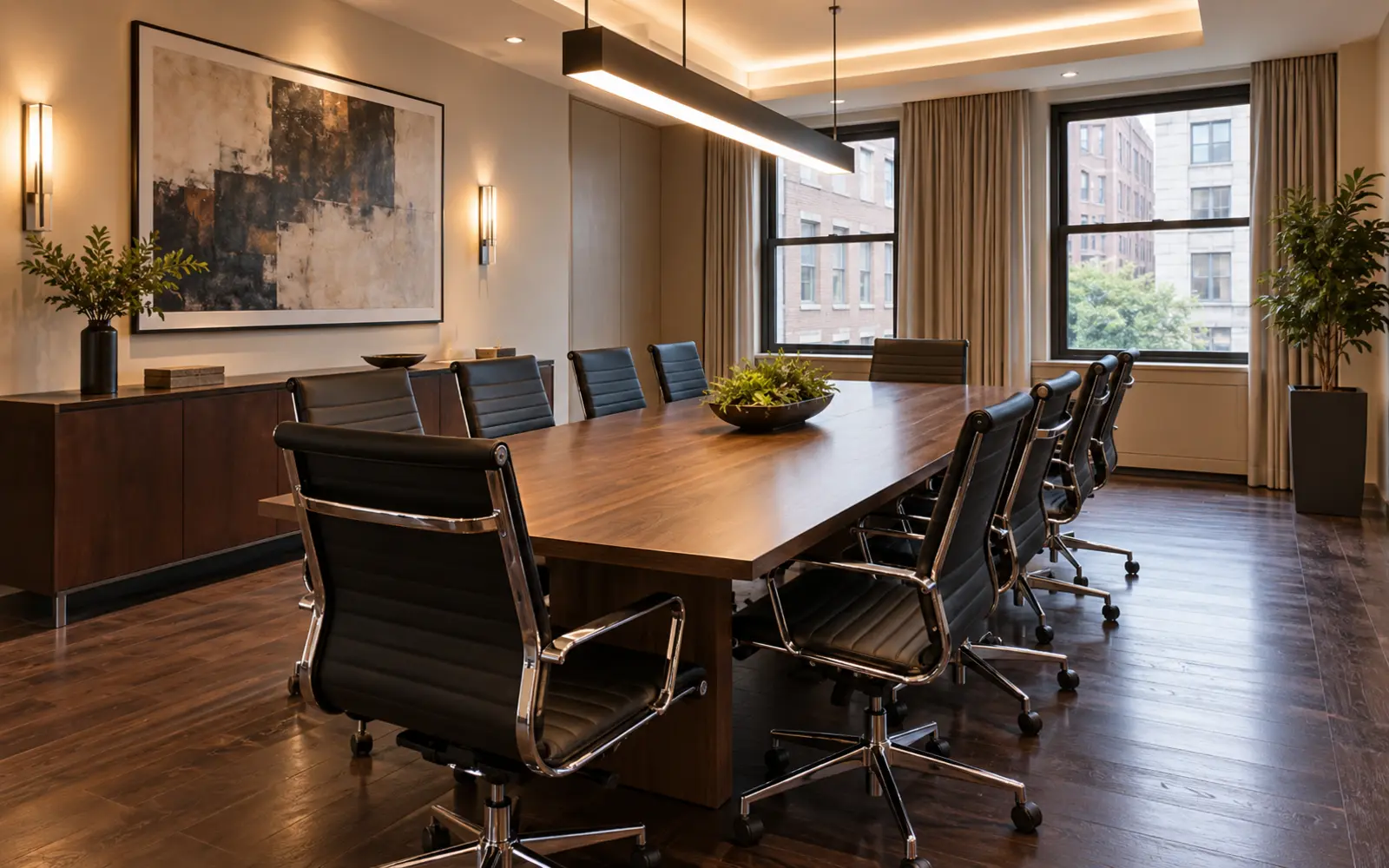 Amenity conference room with black leather conference chairs around a long table