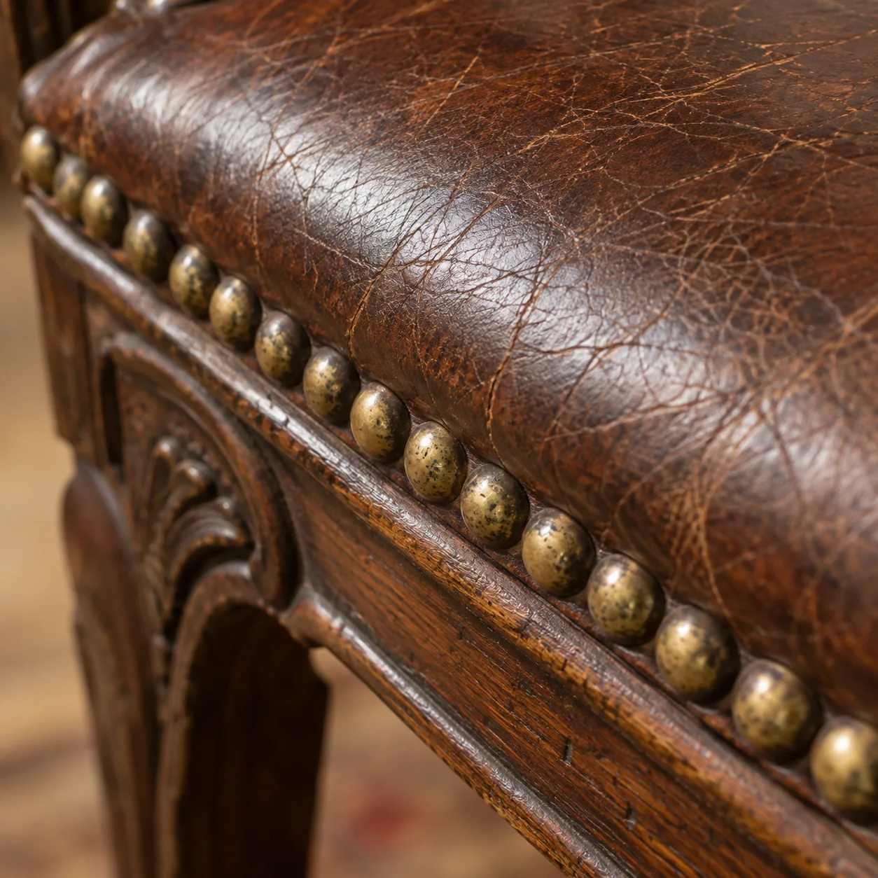 Original brass nailheads along an antique leather seat edge