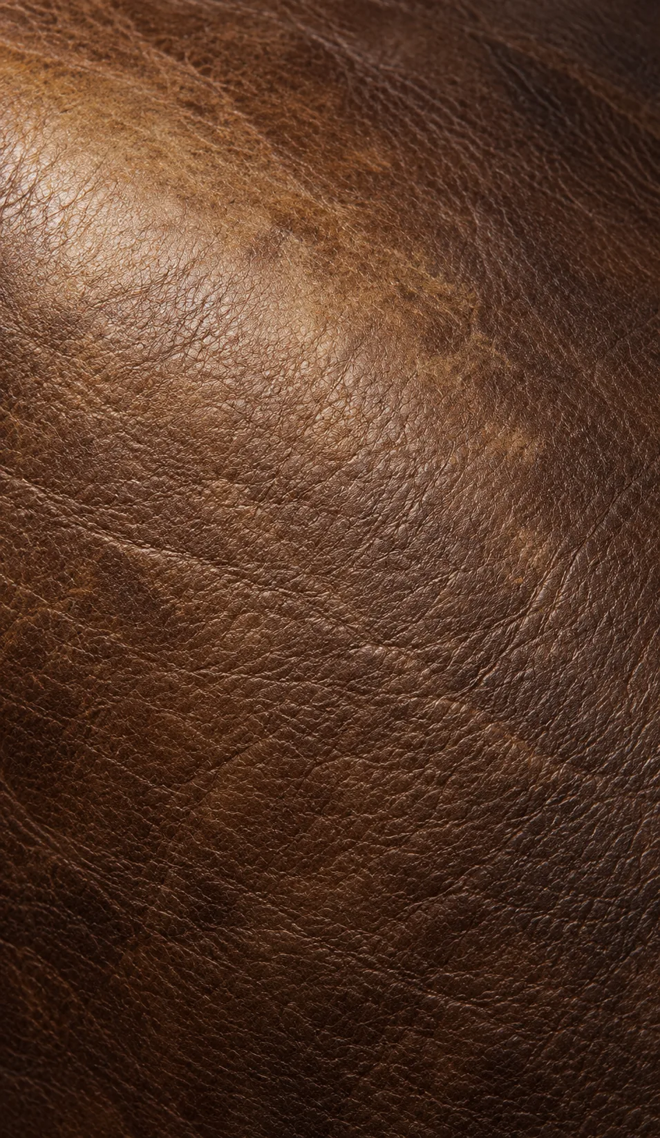 Brown leather faded unevenly across the grain