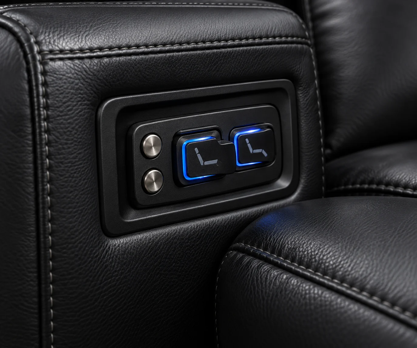 Backlit recline control pad set into the arm of a black home theater seat