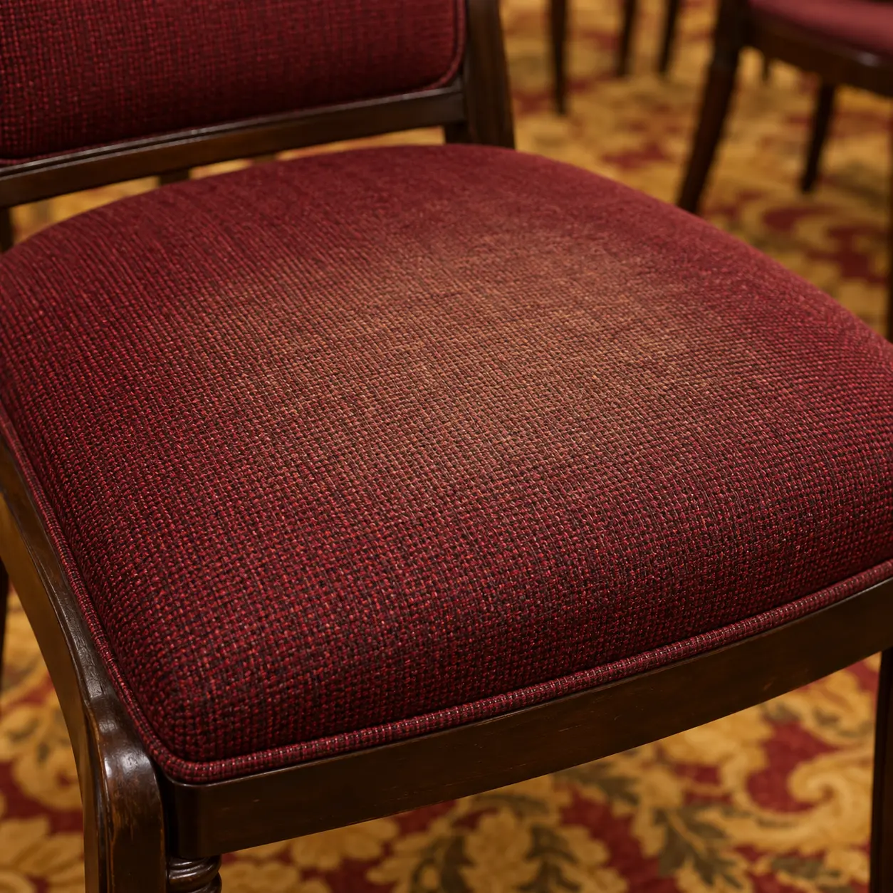 Faded, tired fabric on a banquet chair seat