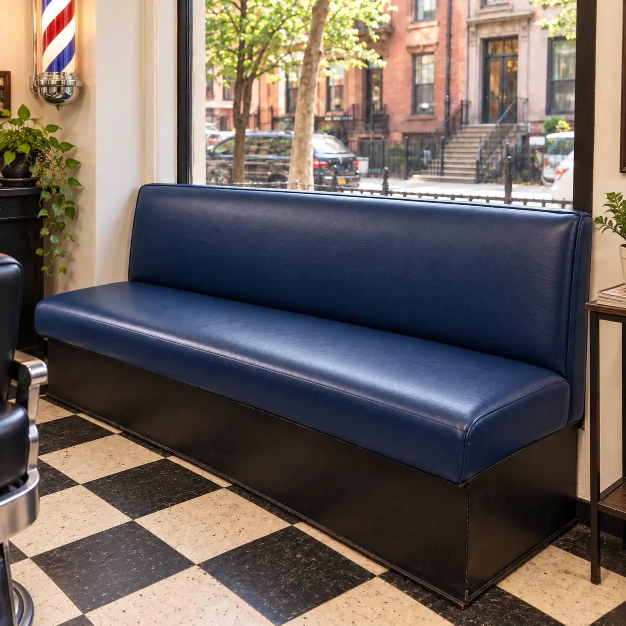 A navy vinyl waiting bench in a barbershop