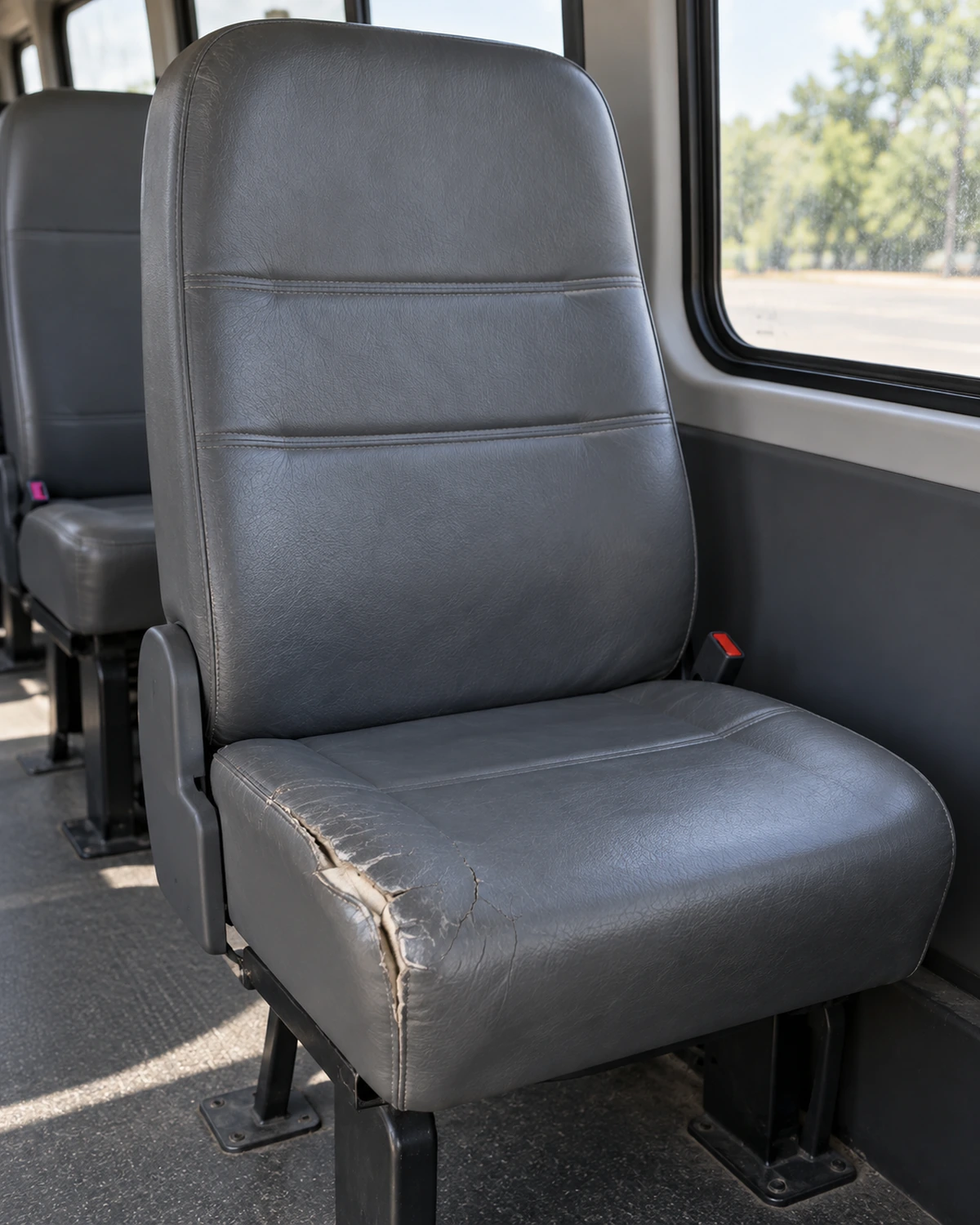 A shuttle seat with split, cracked vinyl
