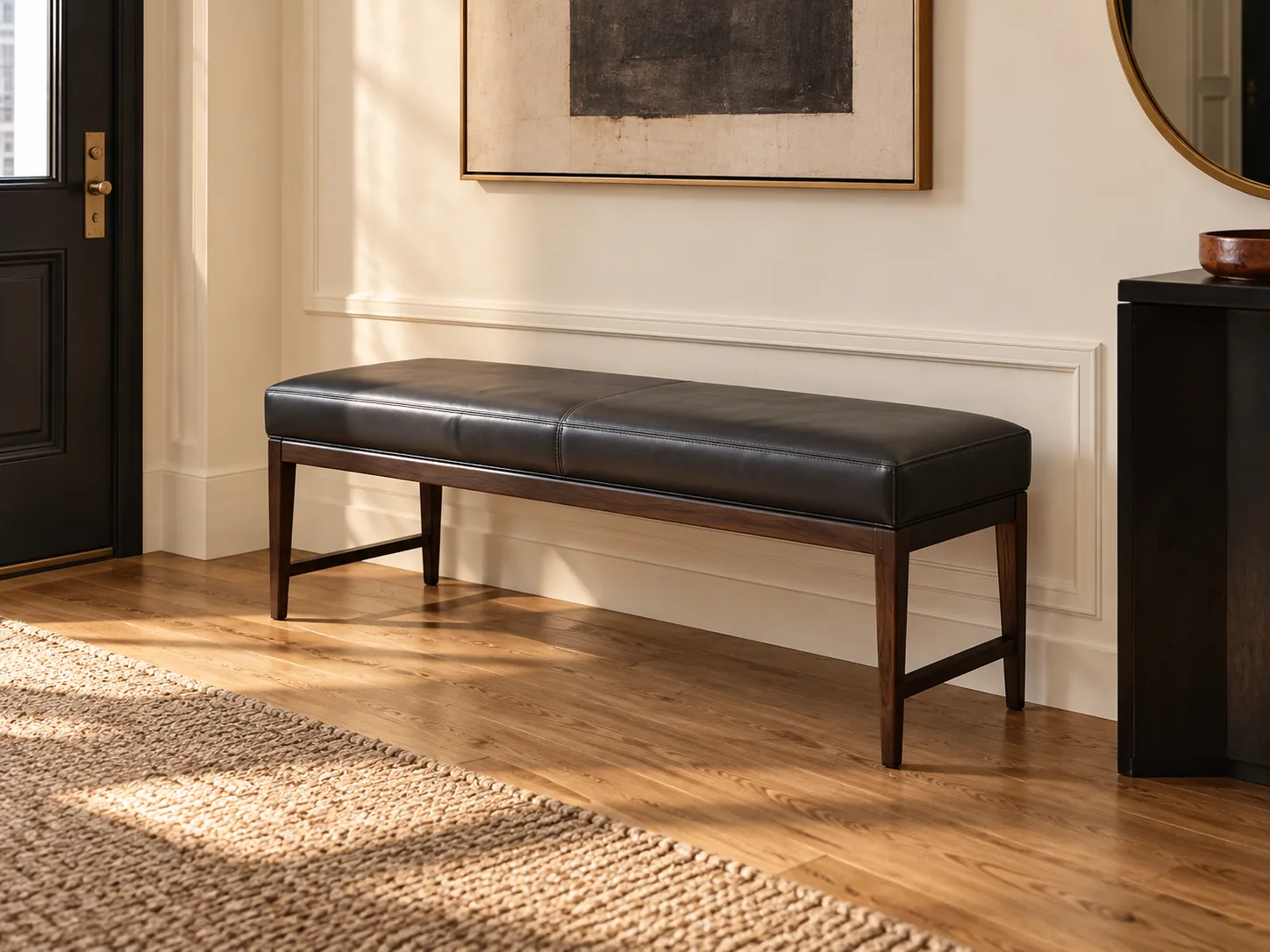 A black leather bench in an entryway