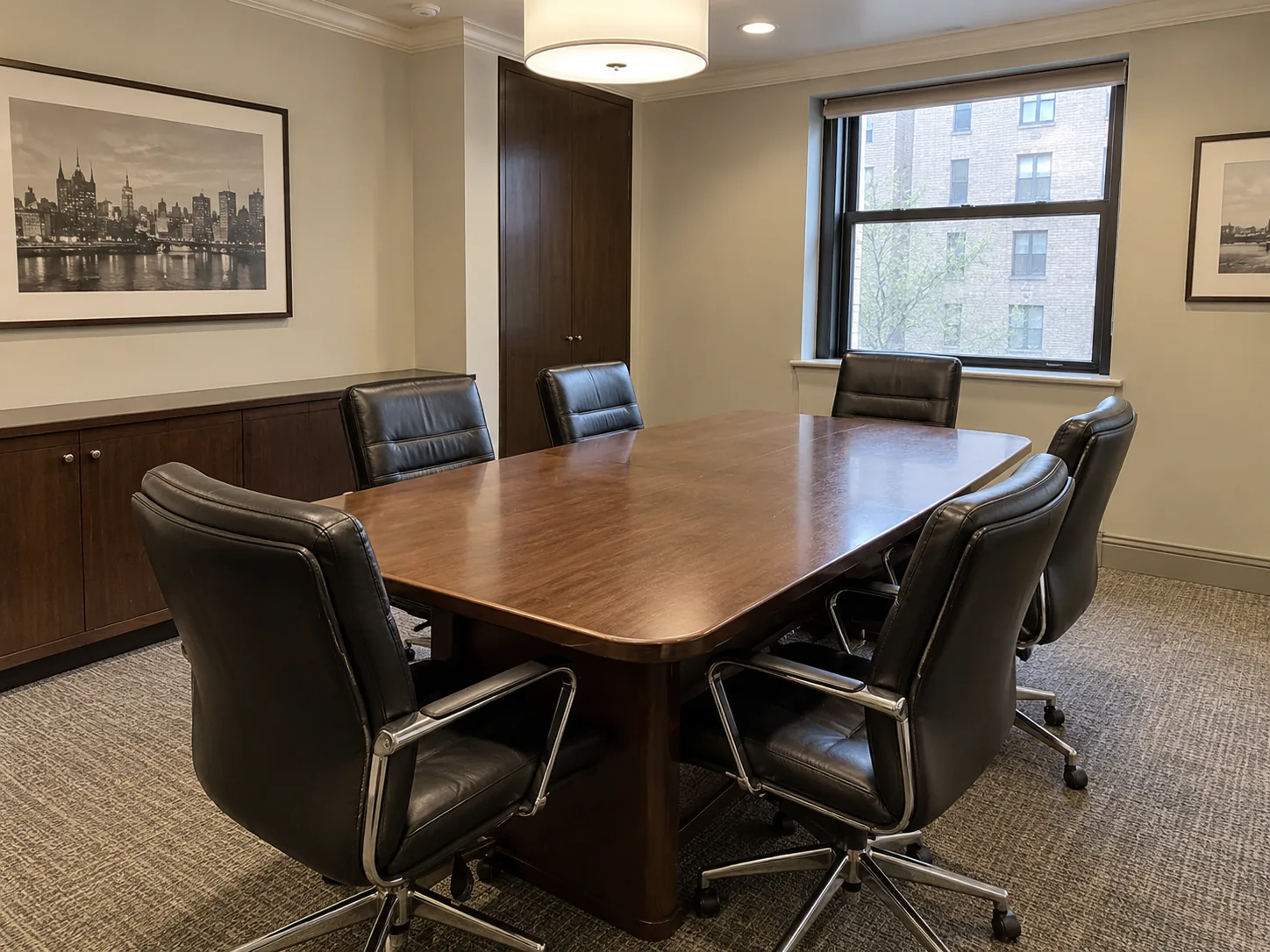 Black leather chairs around a boardroom table