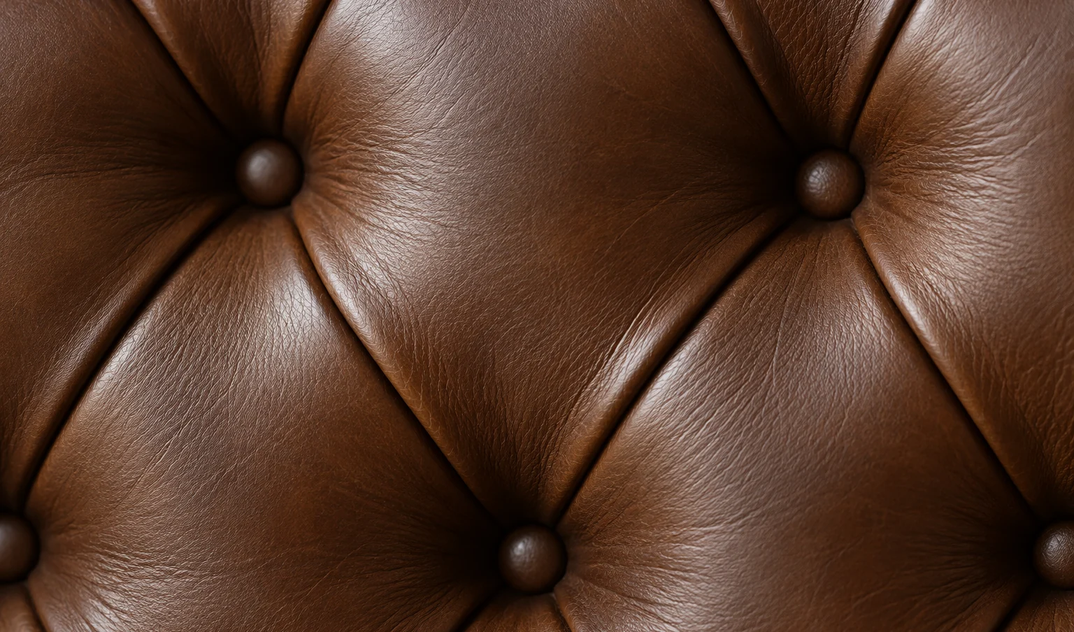 Brown leather worked into a regular diamond tufting pattern with buttons at each intersection