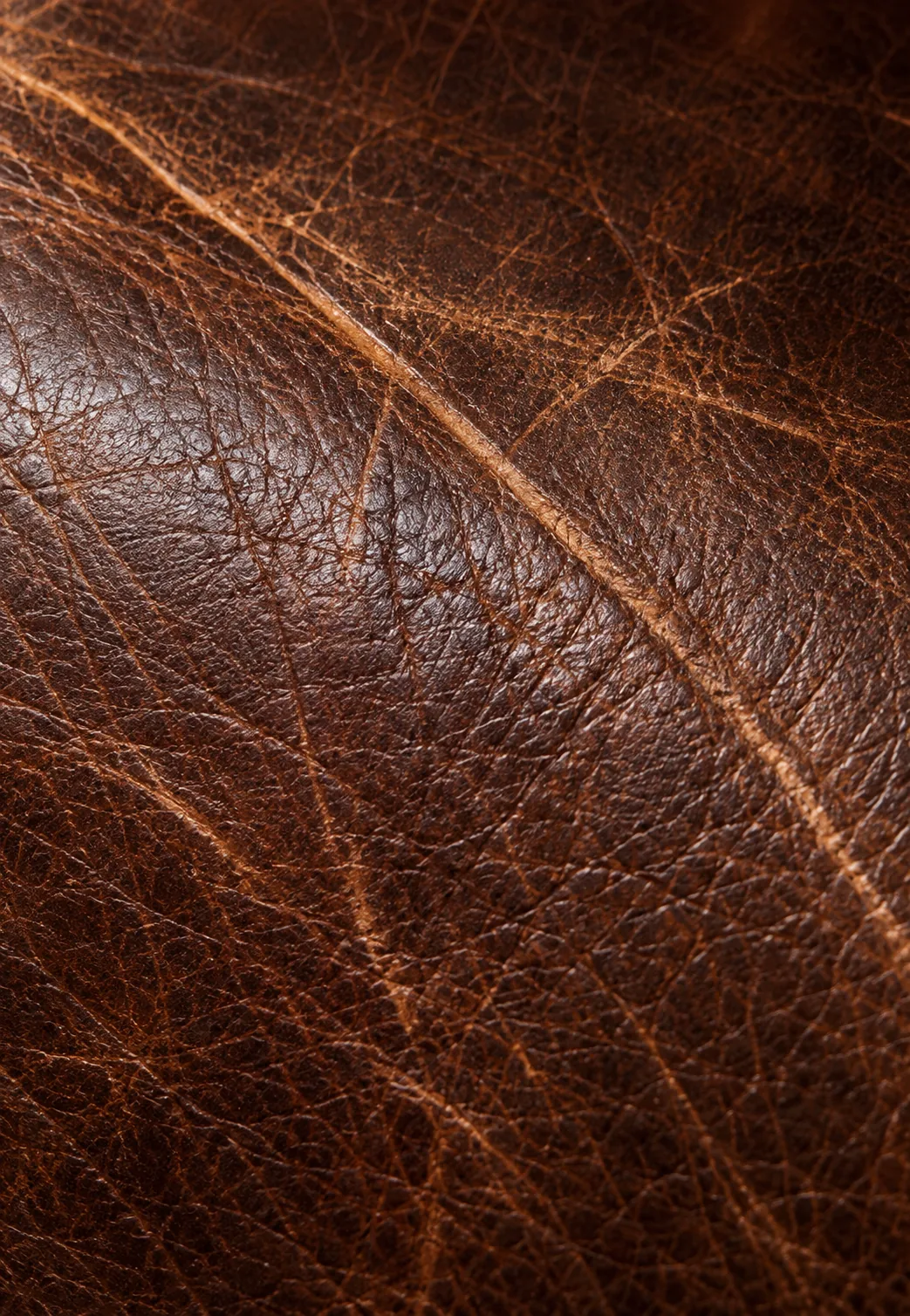 Close-up of natural scratches on brown leather