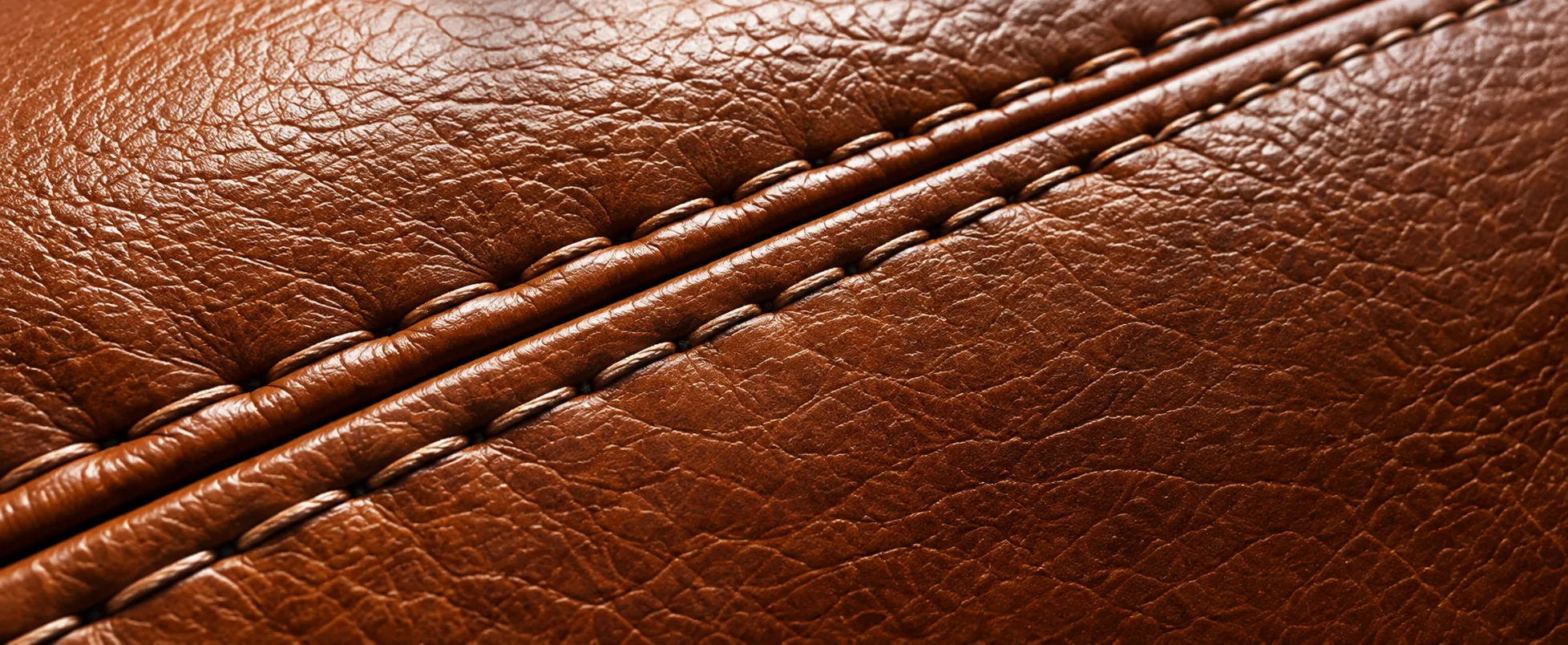 Close-up of a stitched seam in tan office chair leather