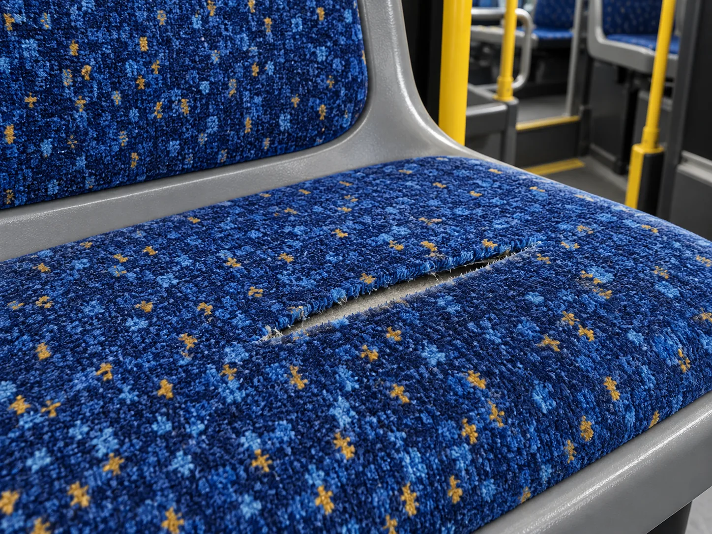 A damaged bus seat with the repair kit open on the seat beside it