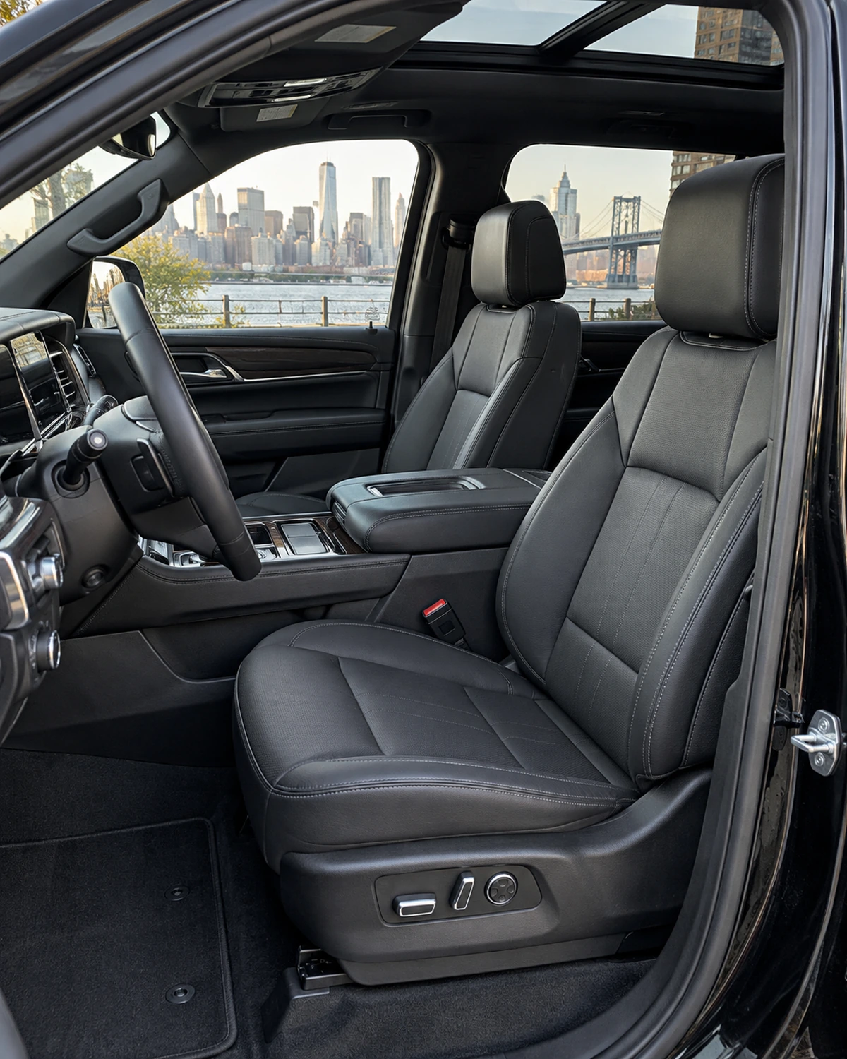 Front leather seats in a car with the door open