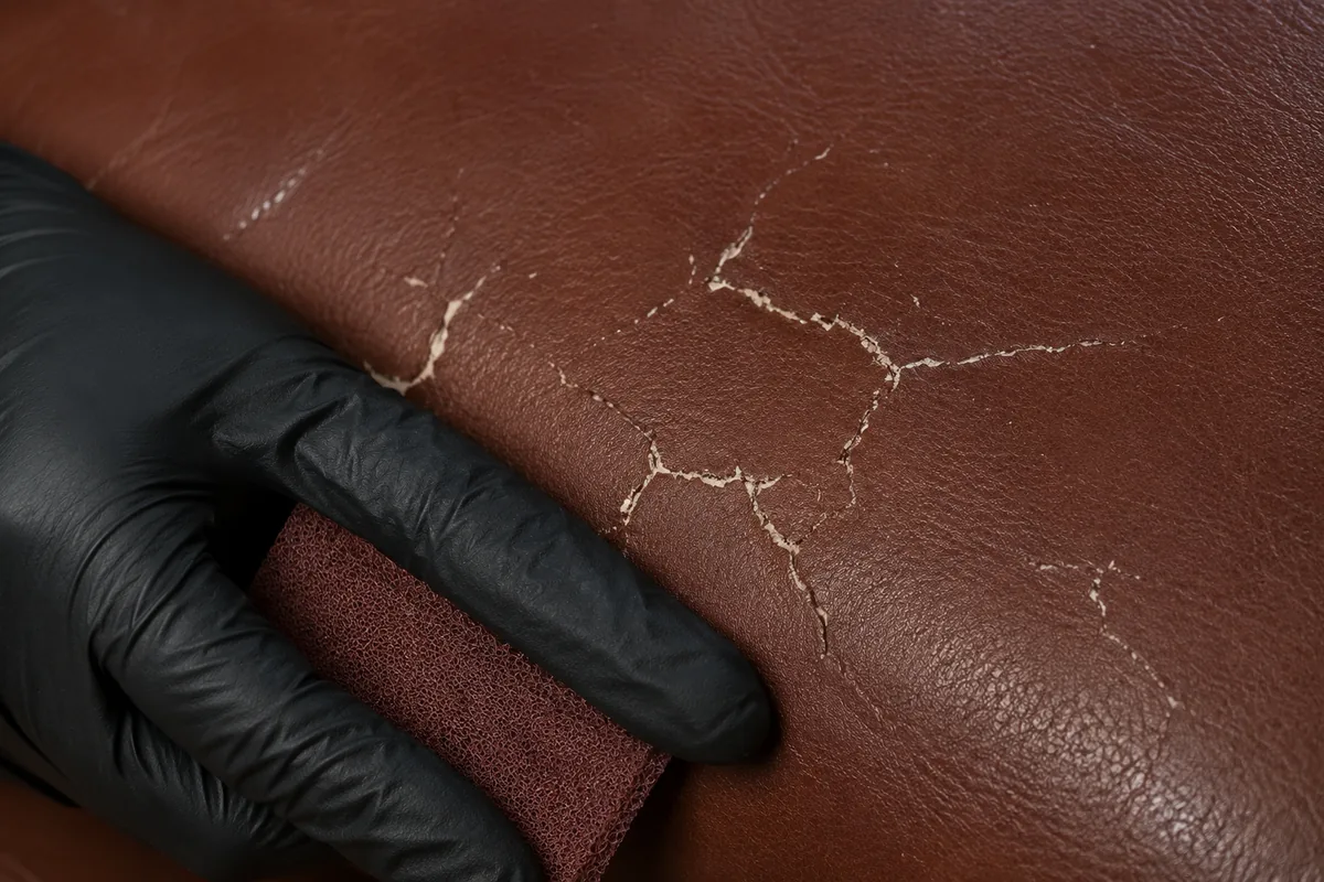 Filler worked into cracked leather in place