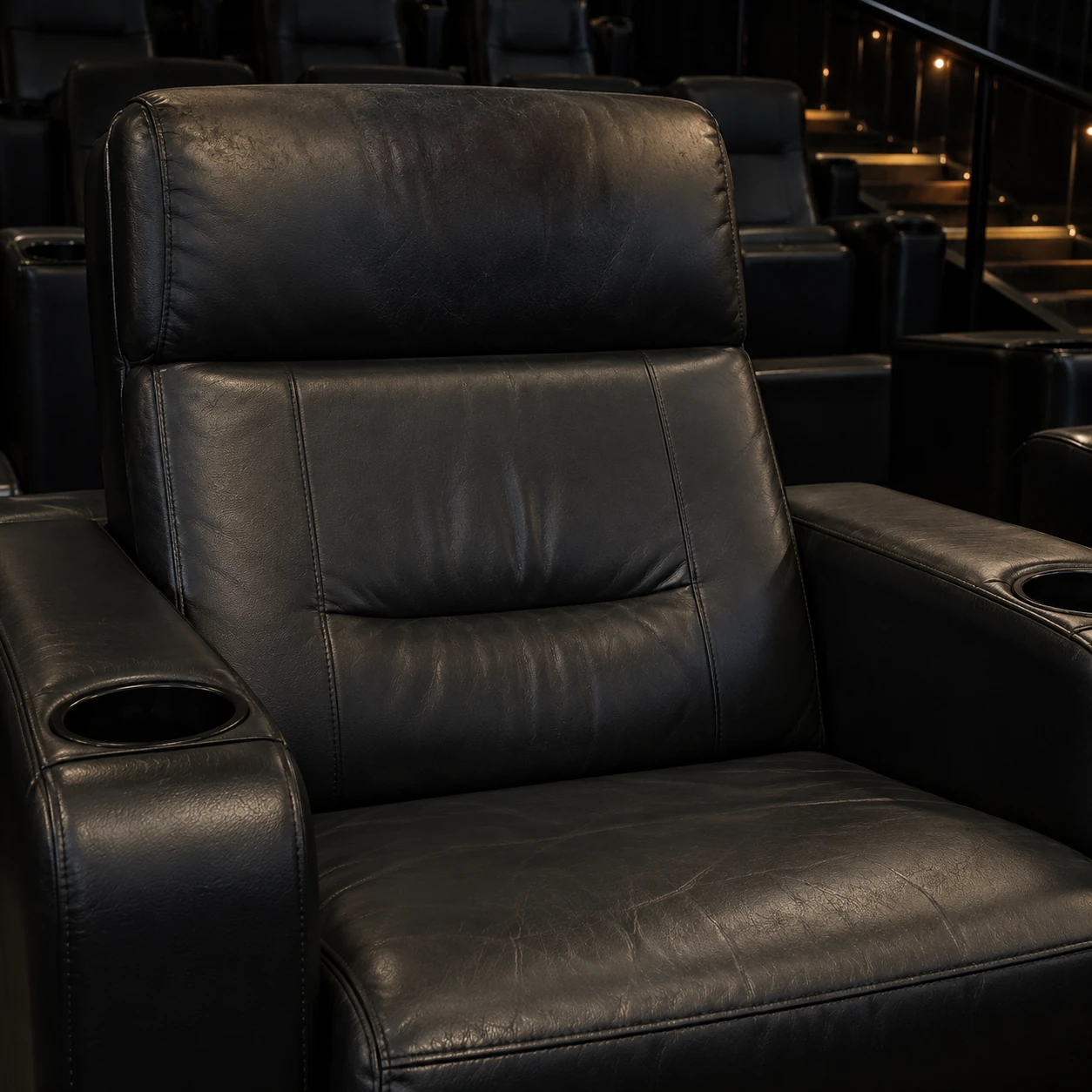 A worn headrest on a cinema recliner