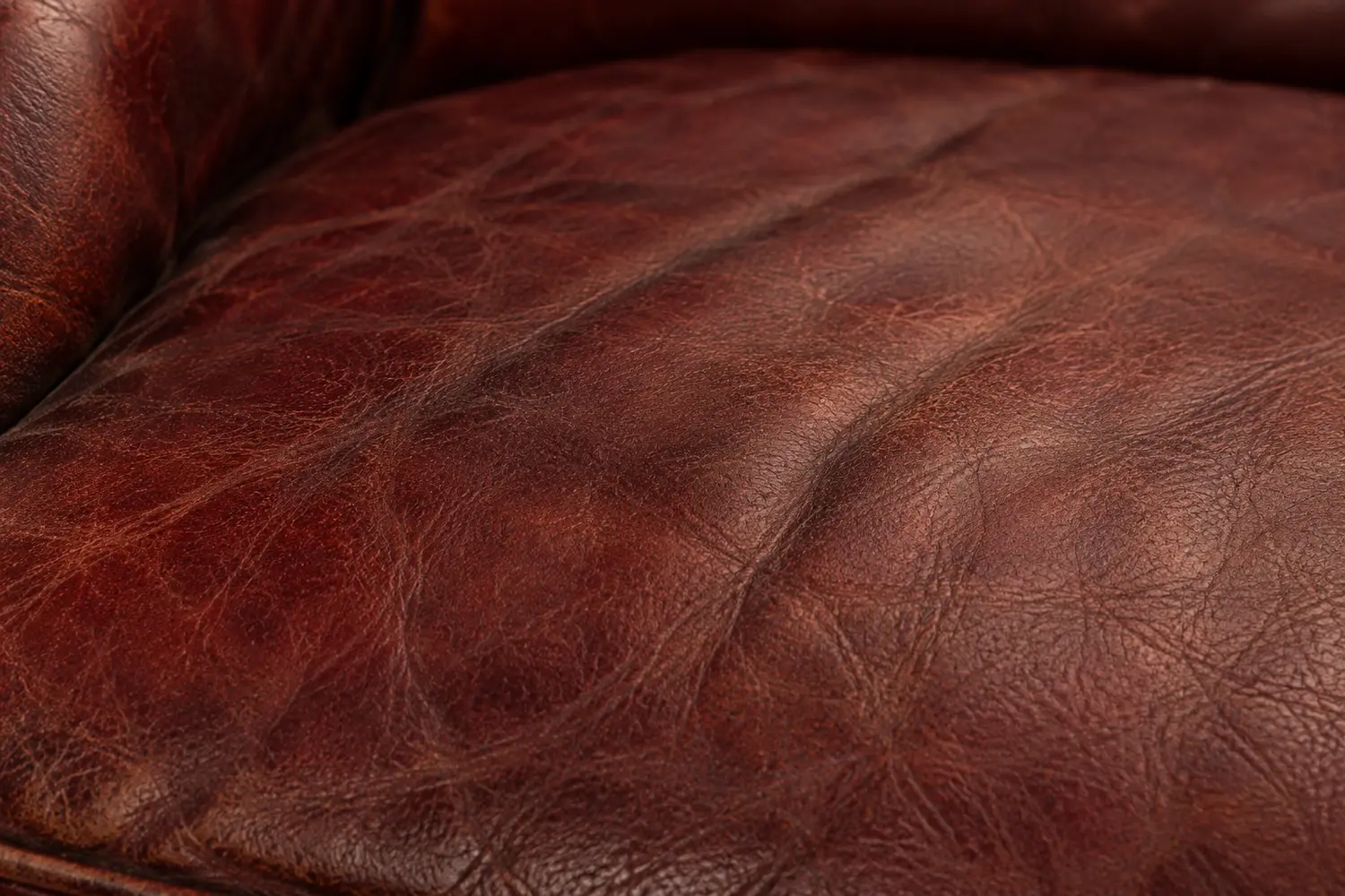 Dull worn topcoat on red leather