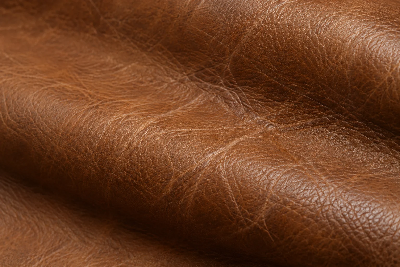 A draped cognac hide with a heavy distressed grain