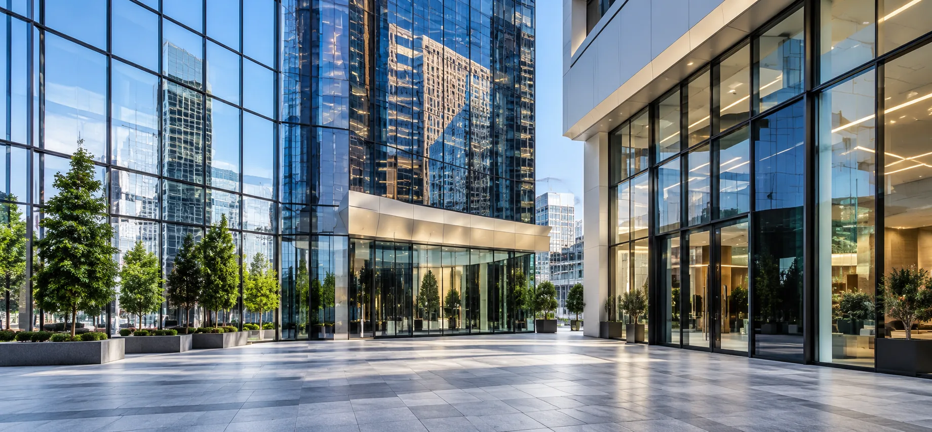 Commercial office tower plaza with managed lobby seating inside