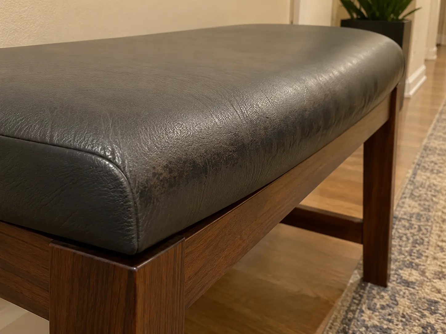 Ingrained grime along the edge of a common area bench
