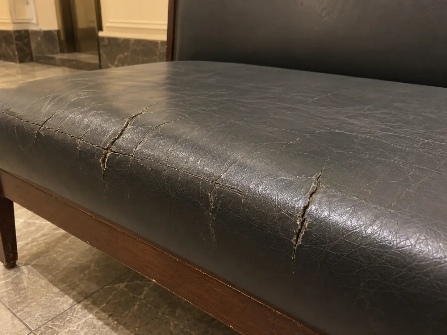 Cracked vinyl seat on a bench