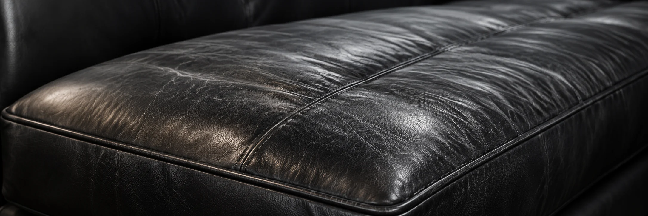 Close view of a black leather seat cushion