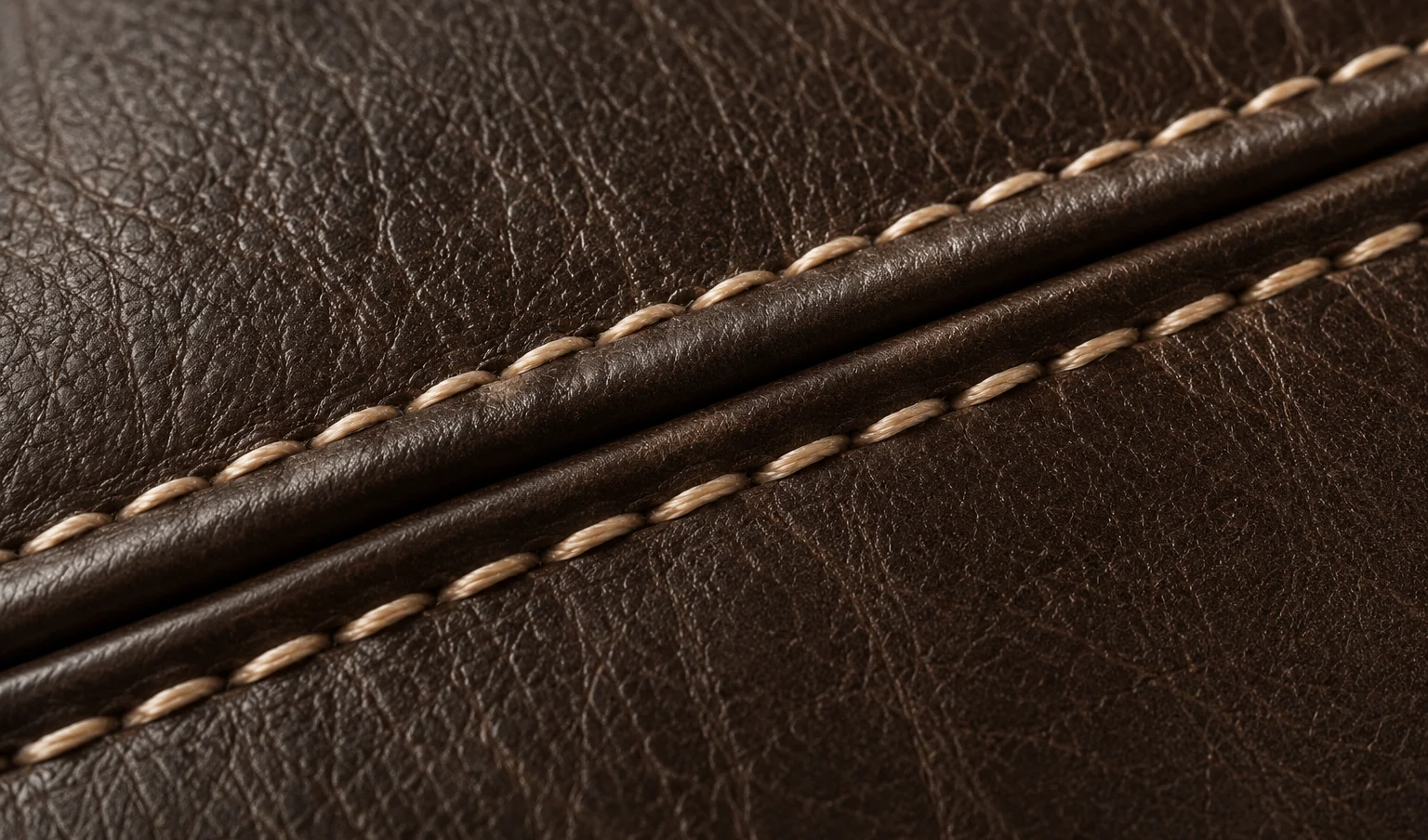 Pale contrast stitching worked across brown bed leather