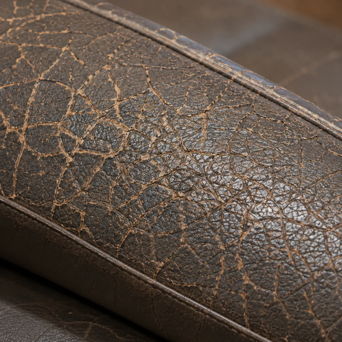 Cracked, crazed vinyl along the edge of a dental stool seat