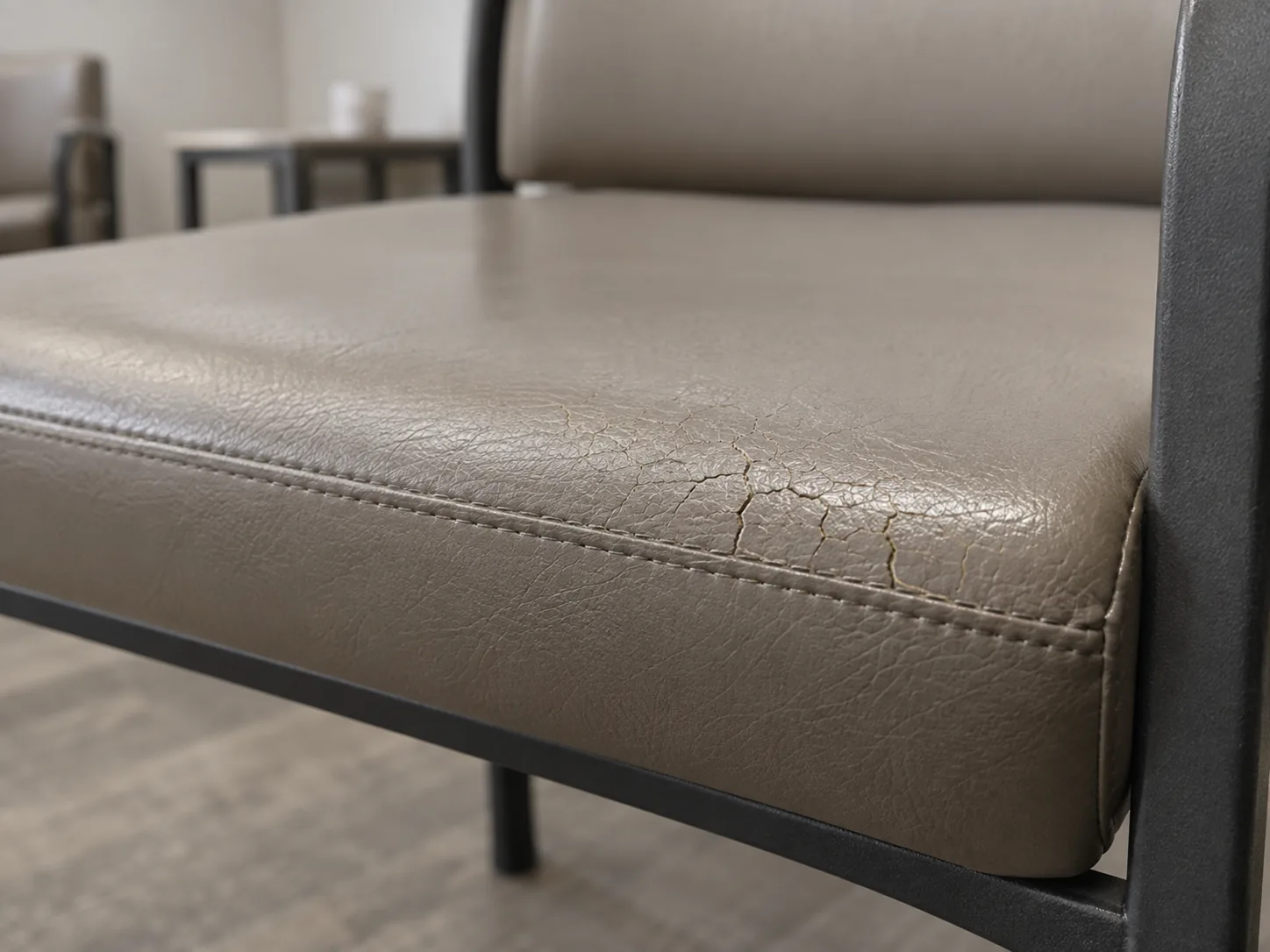 Cracked vinyl along the front of a waiting room chair seat