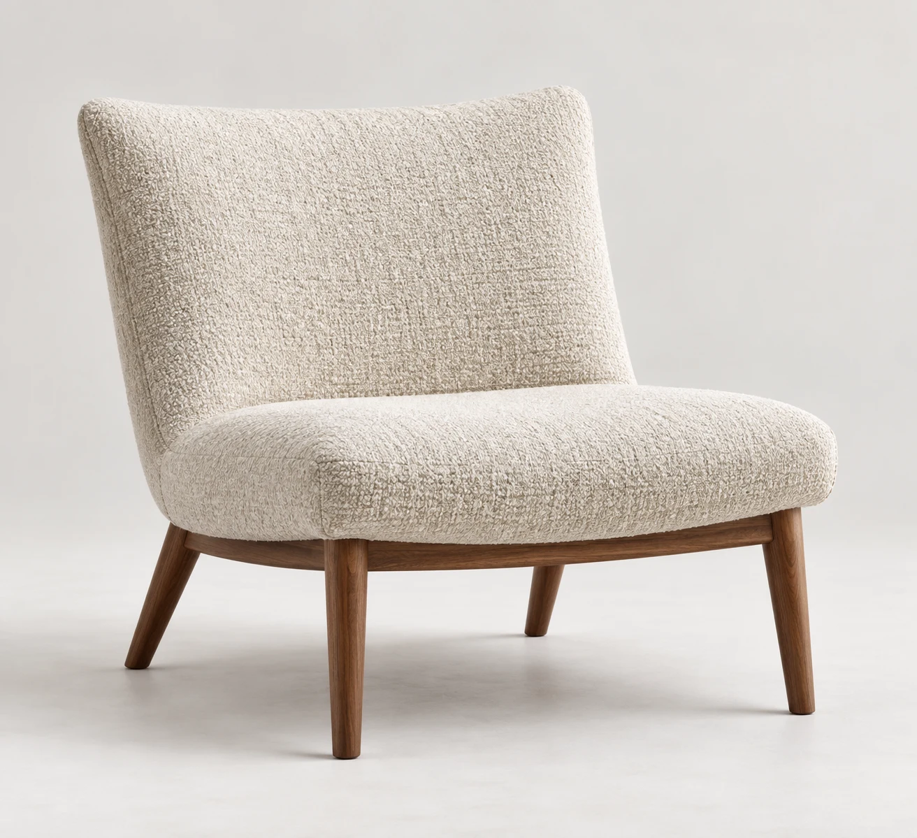 Cream boucle lounge chair on walnut legs