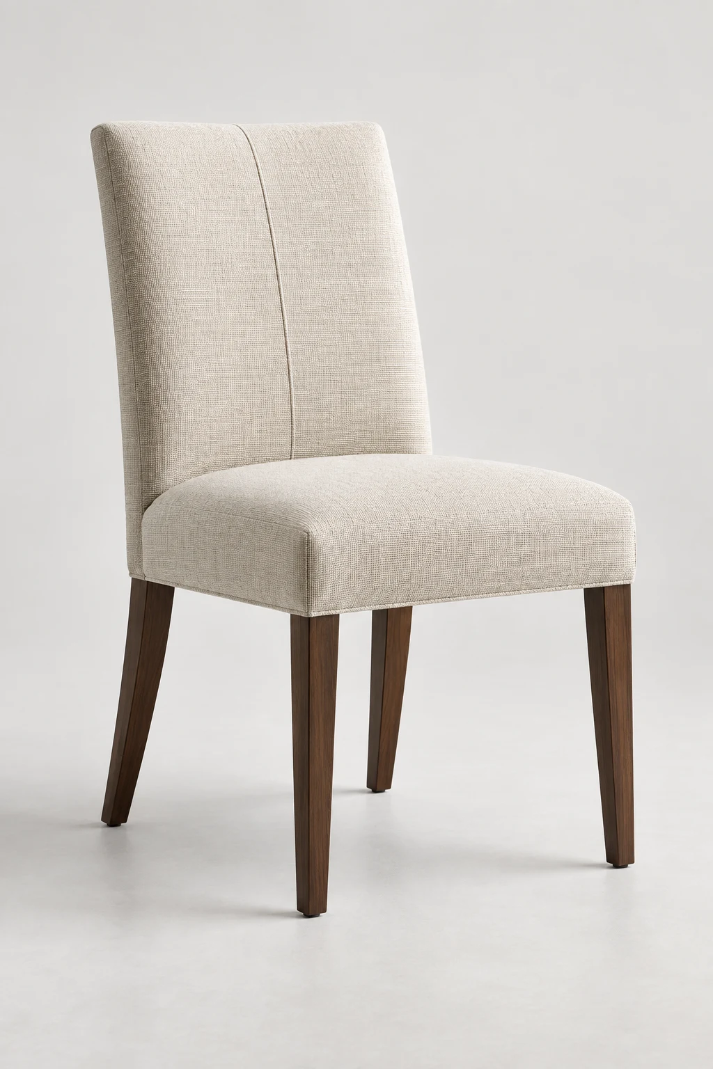 Cream linen side chair with a plain back and tapered wood legs