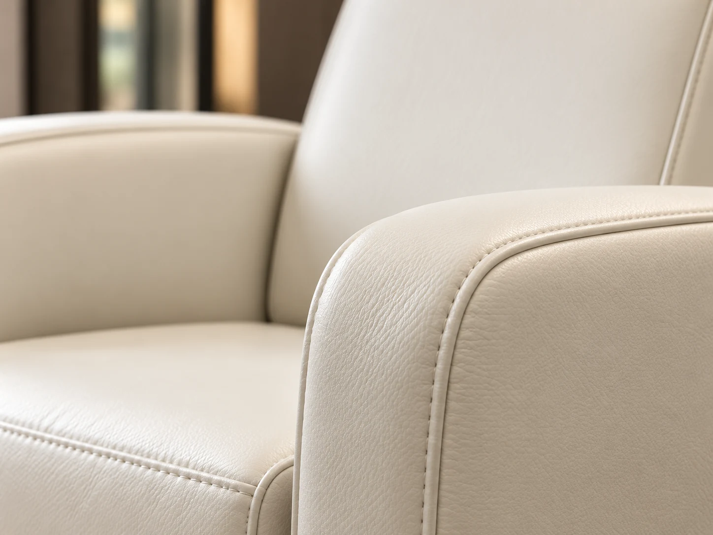 Close view of the stitched seam where a cream vinyl seat meets the arm of a spa chair