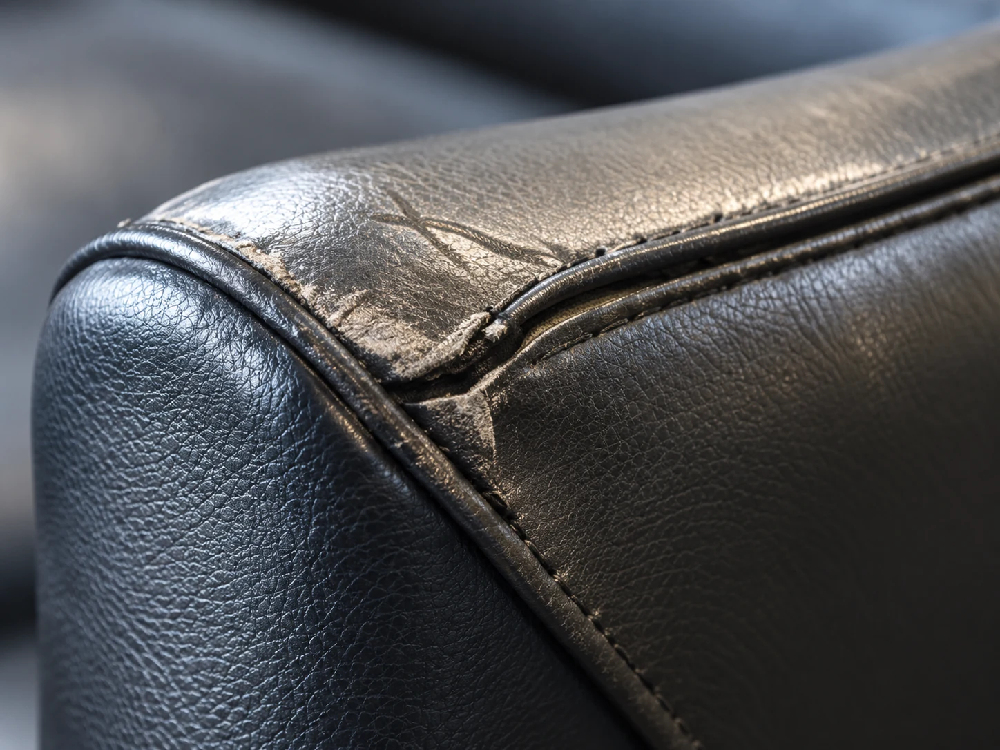 Creased leather at an arm front corner